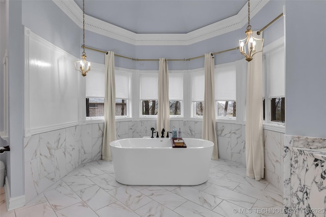 bathroom featuring a tub, tile walls, and a chandelier