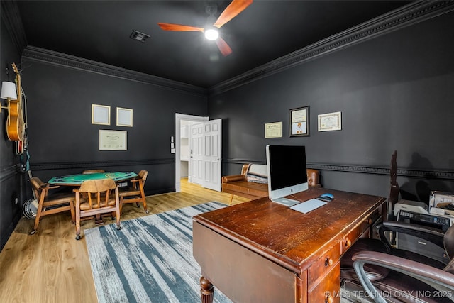 home office with light hardwood / wood-style flooring, ornamental molding, and ceiling fan