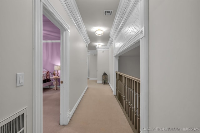 hall with crown molding and light carpet