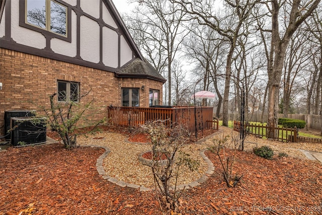 view of yard featuring a wooden deck and cooling unit