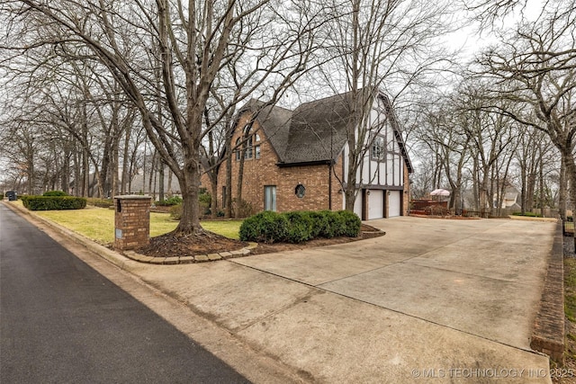 view of property exterior featuring a garage and a lawn