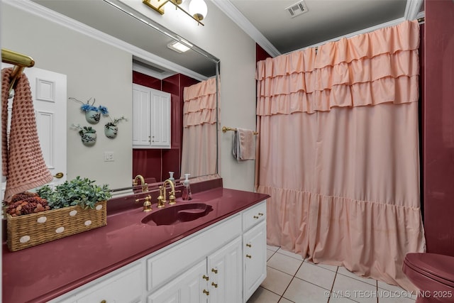 bathroom with crown molding, tile patterned floors, and vanity