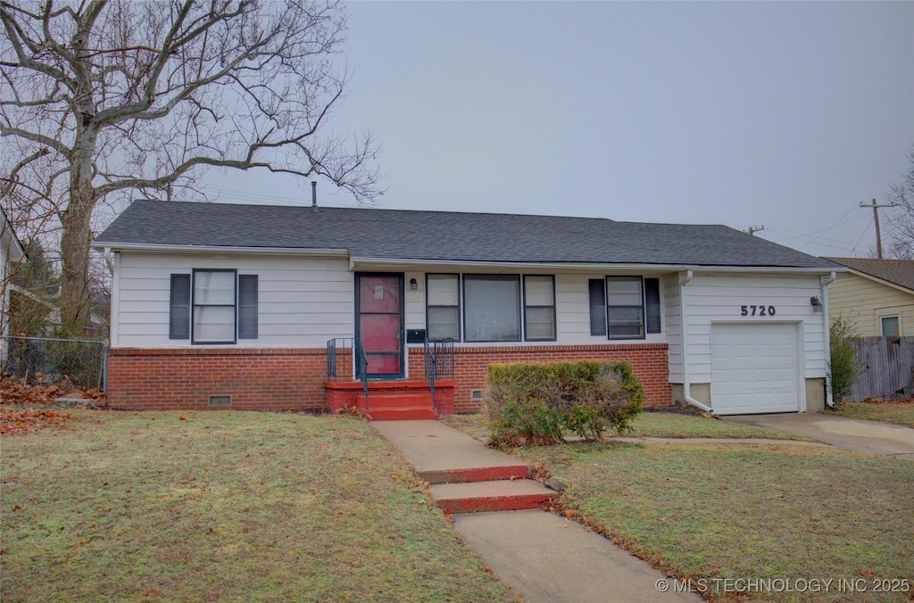 ranch-style house with a garage and a front lawn