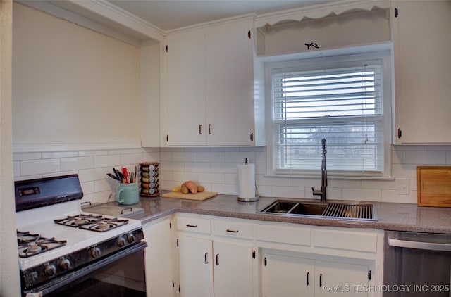 kitchen with dishwasher, white gas range, sink, and white cabinets