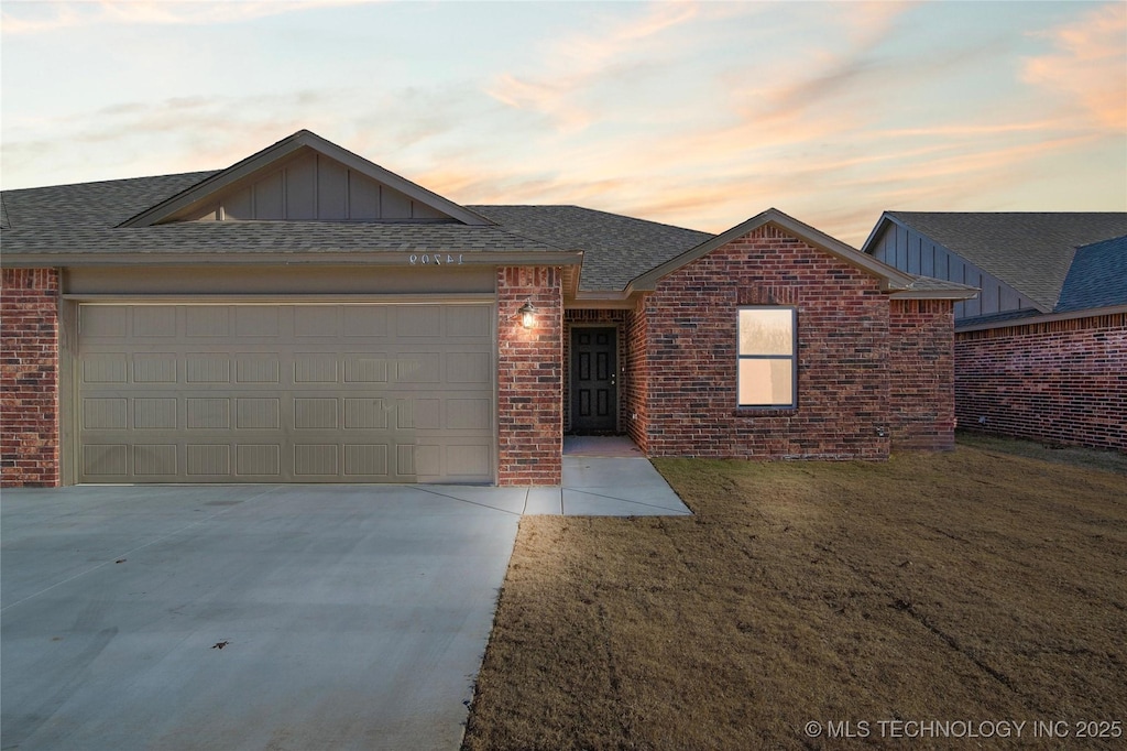 ranch-style house with a yard and a garage