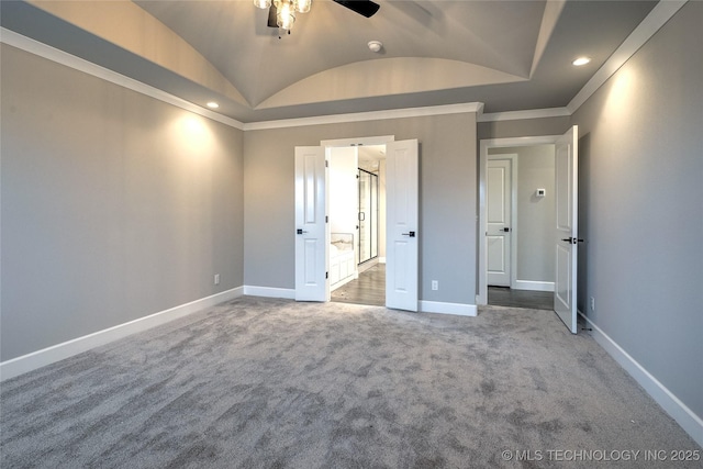 unfurnished bedroom featuring crown molding, vaulted ceiling, and carpet flooring