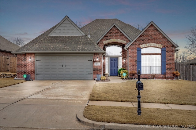 view of front facade with a garage and a lawn