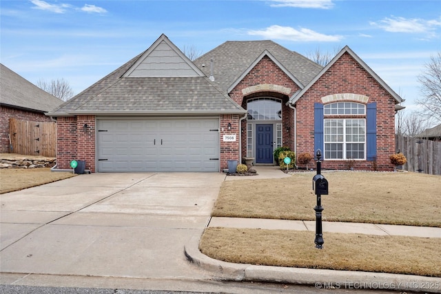 view of front of house with a garage and a front yard