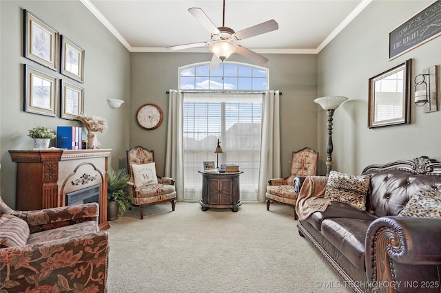 sitting room with ornamental molding, carpet floors, and ceiling fan