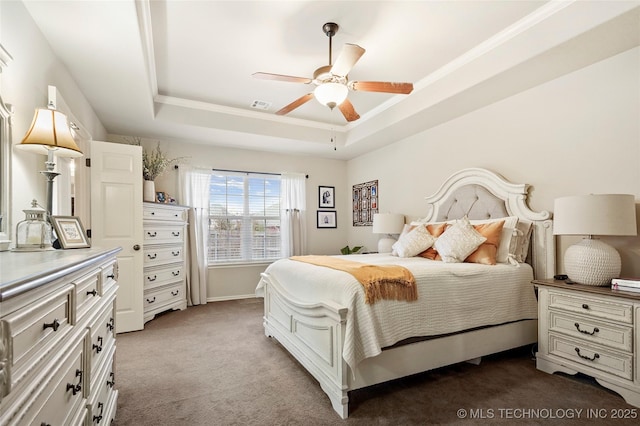 bedroom with a tray ceiling, ornamental molding, light colored carpet, and ceiling fan