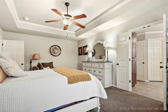 carpeted bedroom featuring ceiling fan, ornamental molding, and a raised ceiling