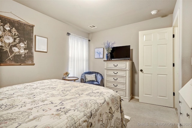 bedroom featuring light colored carpet