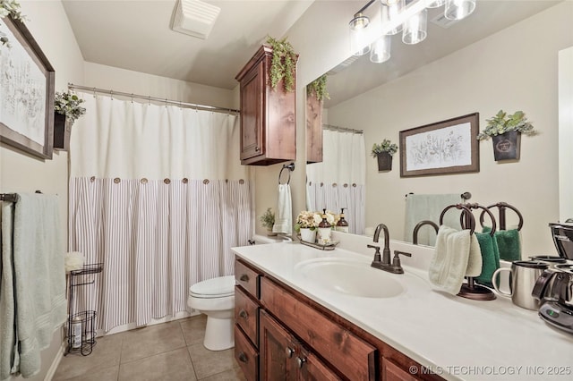 bathroom featuring tile patterned flooring, vanity, and toilet