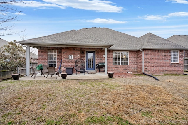 back of house featuring a yard and a patio area