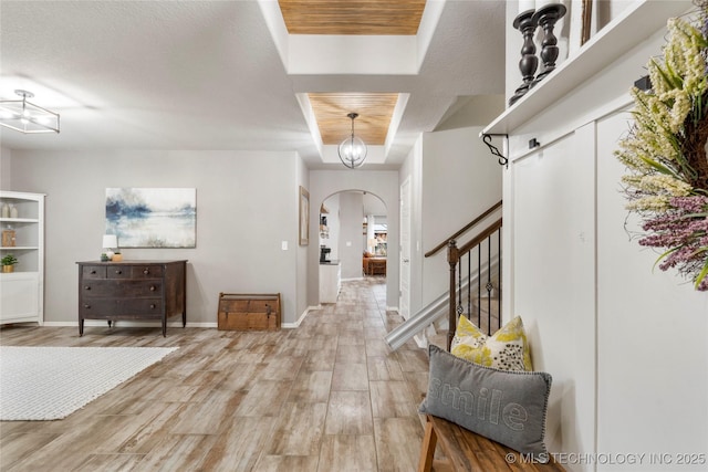 foyer entrance featuring a tray ceiling and hardwood / wood-style flooring