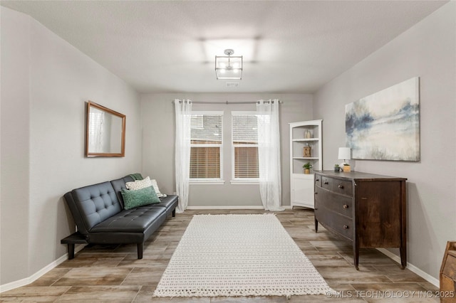 living area featuring a textured ceiling and light wood-type flooring