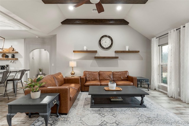 living room featuring vaulted ceiling, light hardwood / wood-style floors, and ceiling fan