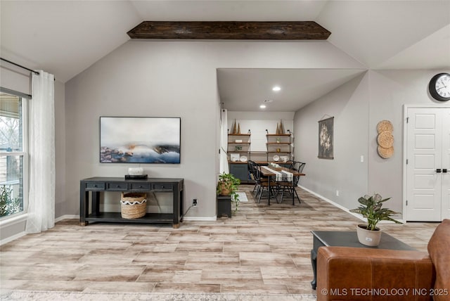 living room with lofted ceiling with beams and light wood-type flooring