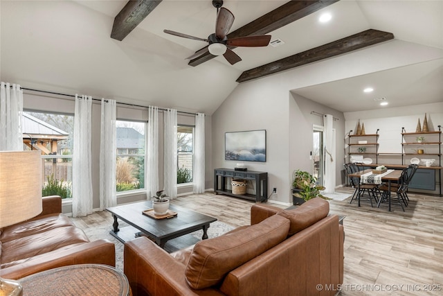 living room with plenty of natural light, light hardwood / wood-style flooring, and vaulted ceiling with beams