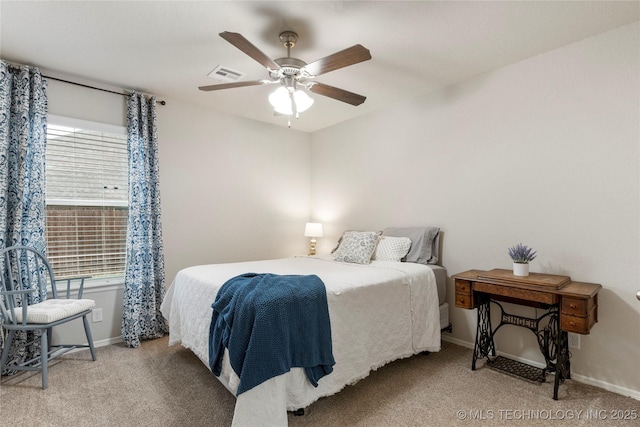 bedroom featuring ceiling fan, multiple windows, and carpet