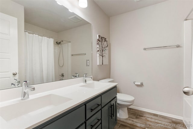 bathroom with vanity, hardwood / wood-style floors, toilet, and walk in shower