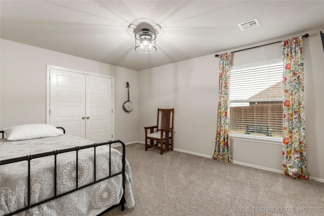 carpeted bedroom with a closet