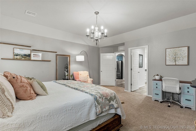 bedroom featuring high quality fridge, ensuite bathroom, a chandelier, and light colored carpet