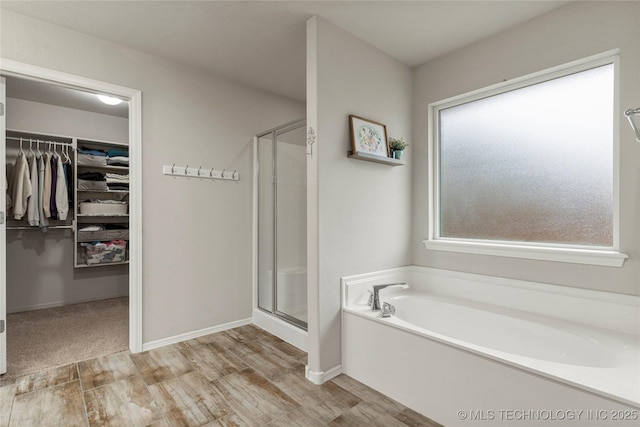 bathroom featuring shower with separate bathtub and hardwood / wood-style floors