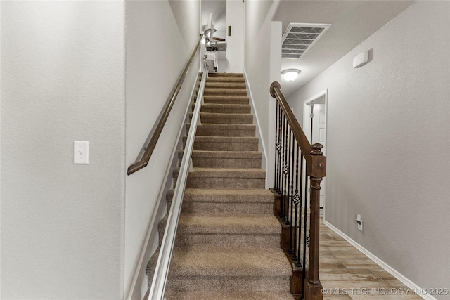 stairs with hardwood / wood-style floors