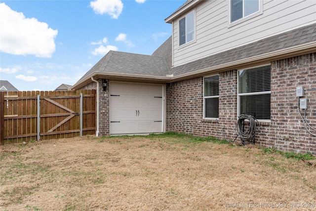 view of property exterior with a garage and a lawn