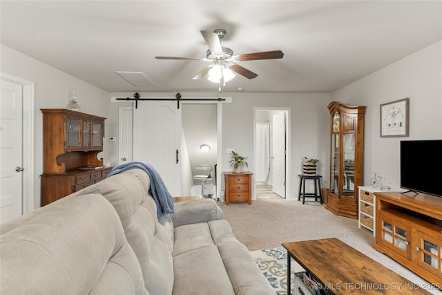 living room with light carpet, a barn door, and ceiling fan