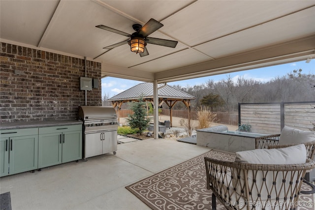 view of patio with a gazebo, grilling area, ceiling fan, and an outdoor kitchen