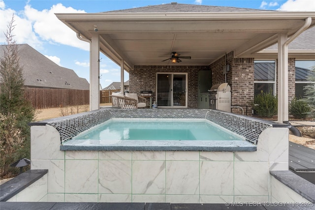 view of pool featuring ceiling fan, an outdoor kitchen, a grill, and an in ground hot tub