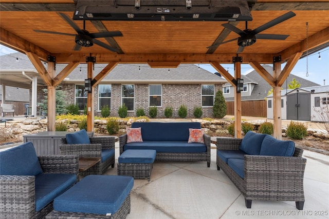 view of patio with ceiling fan, outdoor lounge area, and a shed