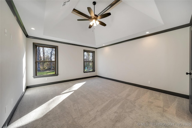 unfurnished room featuring a raised ceiling, crown molding, light carpet, and ceiling fan