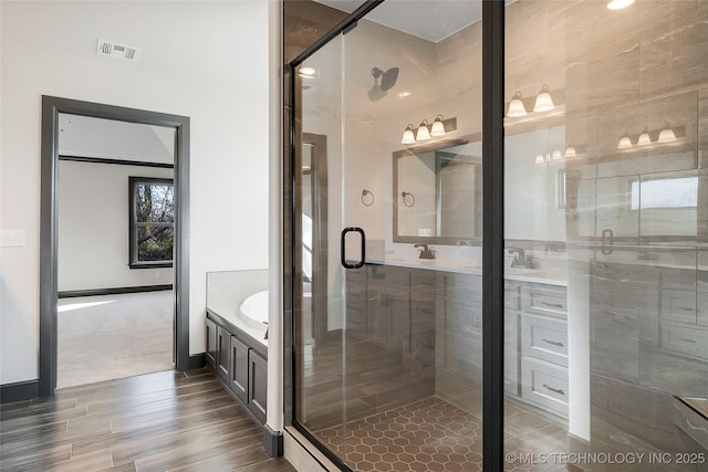 bathroom with vanity, hardwood / wood-style floors, and walk in shower