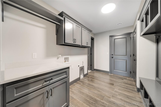 laundry area featuring gas dryer hookup, cabinets, washer hookup, and electric dryer hookup