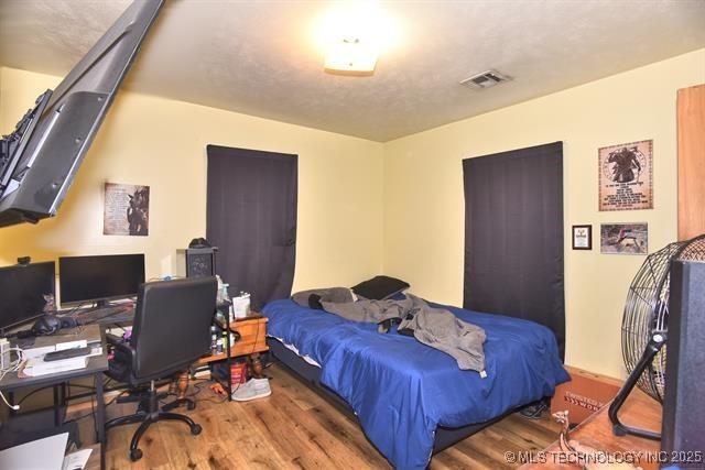 bedroom with wood-type flooring