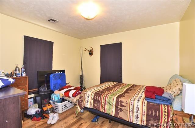 bedroom featuring hardwood / wood-style flooring