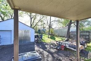 view of patio featuring a garage and an outdoor structure