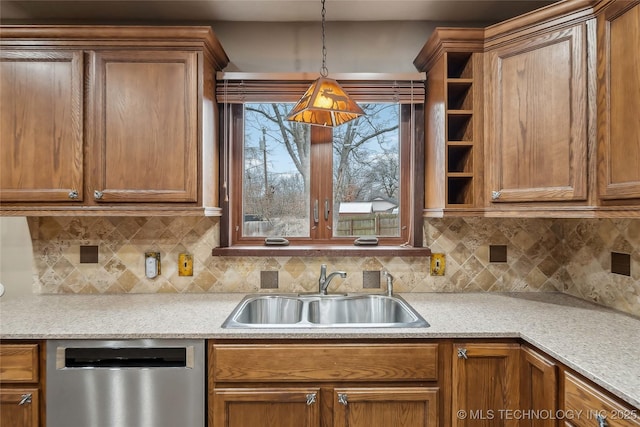 kitchen featuring tasteful backsplash, sink, decorative light fixtures, and dishwasher