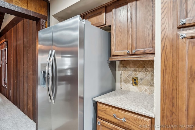 kitchen with tasteful backsplash and stainless steel refrigerator with ice dispenser