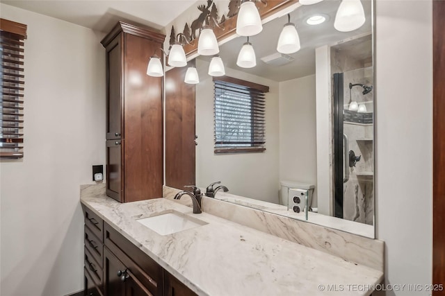 bathroom featuring vanity, toilet, and walk in shower