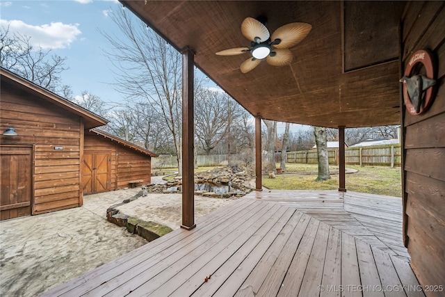 wooden terrace featuring ceiling fan and a patio area