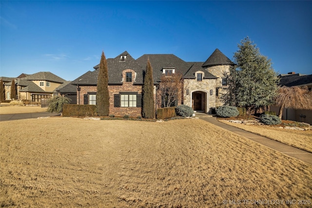 french country style house featuring a front lawn