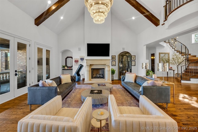 living room with high vaulted ceiling, wood-type flooring, a chandelier, beam ceiling, and french doors