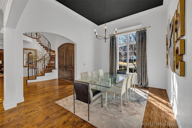 dining room with hardwood / wood-style floors and a notable chandelier