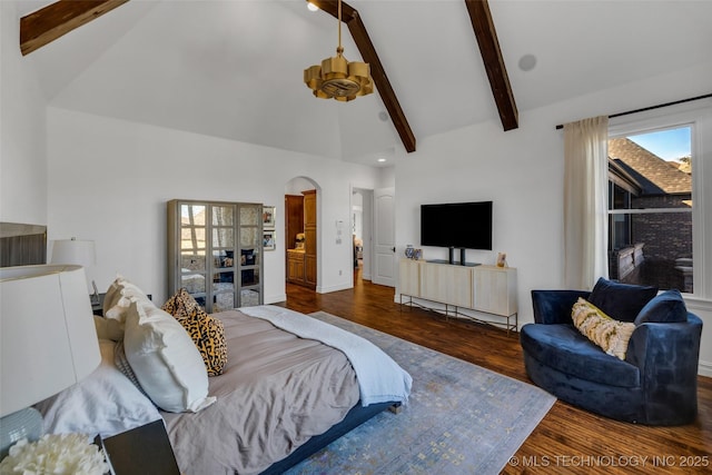 bedroom with beamed ceiling, dark hardwood / wood-style floors, and high vaulted ceiling