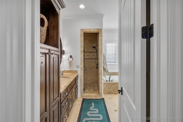 bathroom featuring plus walk in shower, vanity, and tile patterned floors