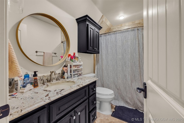 bathroom with vanity, curtained shower, and toilet